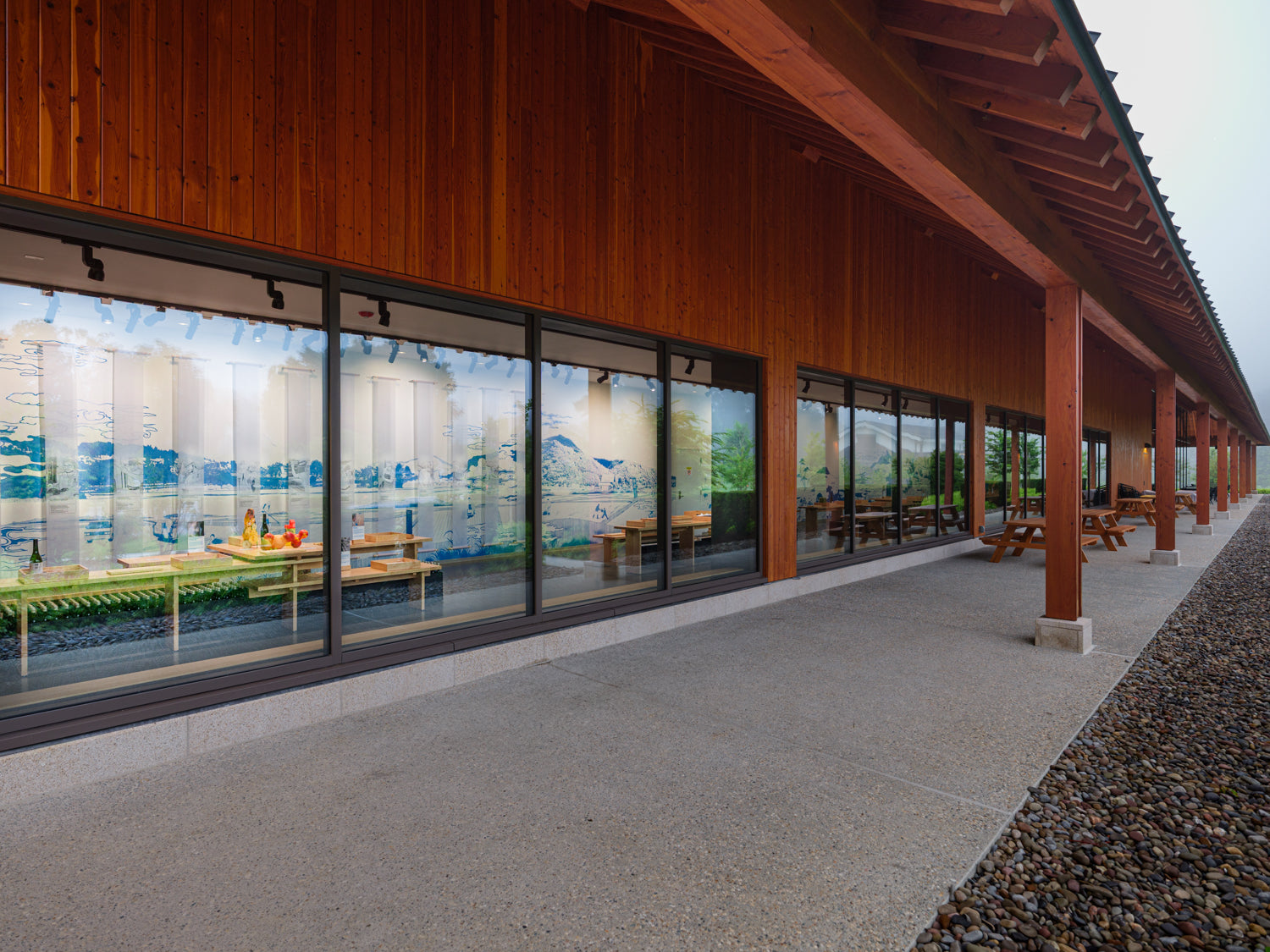 Dassai Blue Sake Brewery building with large glass windows and wooden exterior